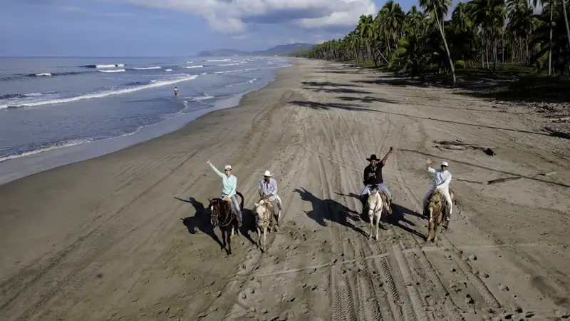 Horseback riding on endless beach